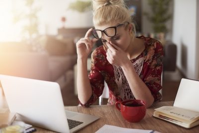 Woman working at home with a headache