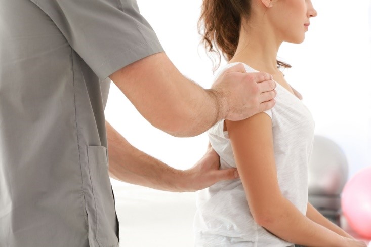 Physiotherapist working with patient in clinic, closeup