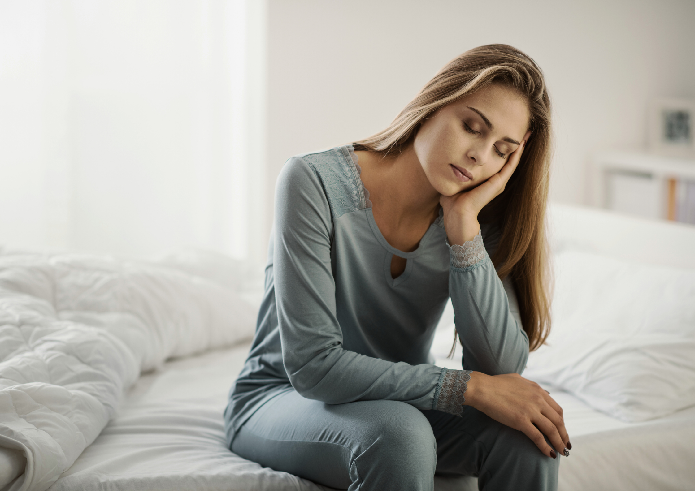Woman sitting on bed holding her neck in pain, representing neck pain and poor posture caused by stress, poor sleep, and spinal tension — common issues treated at Northbridge Chiropractic in Perth.