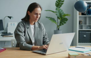 Professional woman working at home office desk