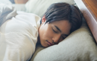 Young Man Peacefully Sleeping in Bed